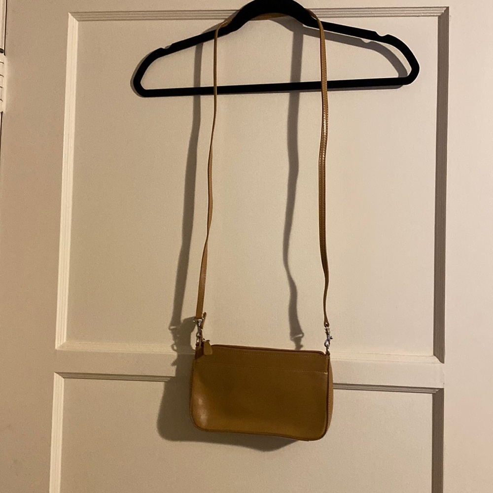 New. Never used. Small tan clutch/cross body purse